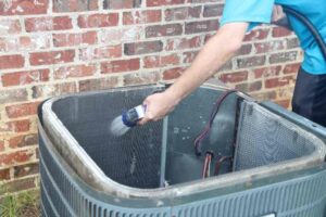 Man cleaning a air conditioning unit